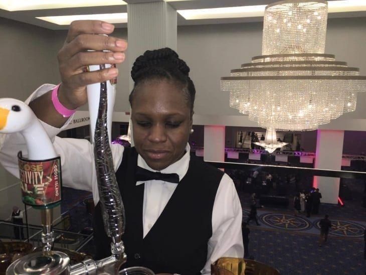 PBS graduate in formal attire at a catering event